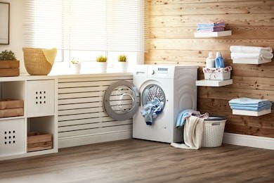 interior of a real laundry room with a washing machine at the window at home
