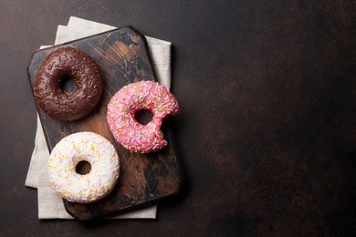 colorful donuts on stone table. top view with copy space