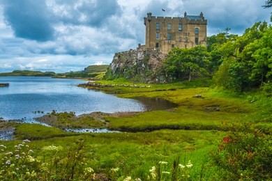 dunvegan castle on the isle of skye, highlands of of scotland. seat of the macleod clan. built on an elevated rock overlooking an inlet on the eastern shore of the sea loch of dunvegan.