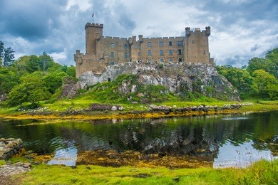 dunvegan castle on the isle of skye, highlands of of scotland. seat of the macleod clan. built on an elevated rock overlooking an inlet on the eastern shore of the sea loch of dunvegan.