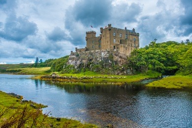 dunvegan castle on the isle of skye, highlands of of scotland. seat of the macleod clan. built on an elevated rock overlooking an inlet on the eastern shore of the sea loch of dunvegan.