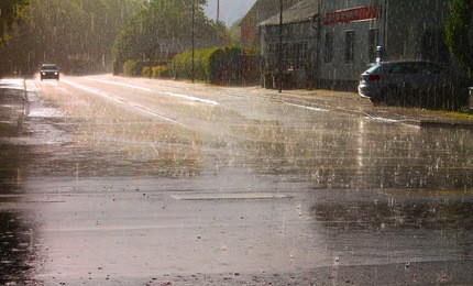 heavy rain and puddles on the road slowing the traffic down