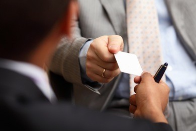 closeup portrait of two successful business executive exchanging business card