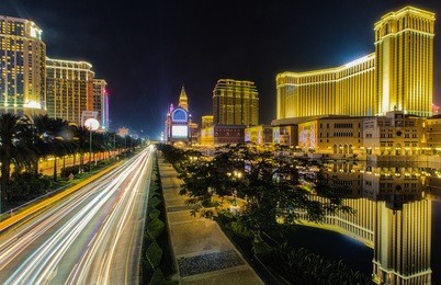 scenic panorama cityscape of macau, china, reflected on lake at sunset. urban night scene.
