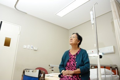 asian ethnic elderly patient woman alone in hospital ward