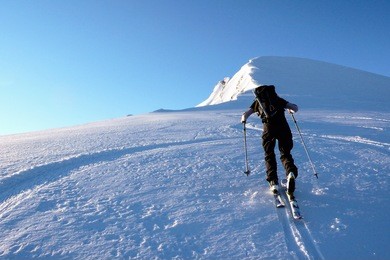 single male on a ski tour in the back country of the swiss alps in fresh powder snow