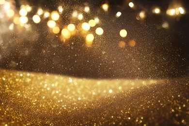 gold and black glitter vintage lights background. defocused.