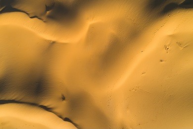 sandy desert texture. lines and pattern. aerial top vertical shot