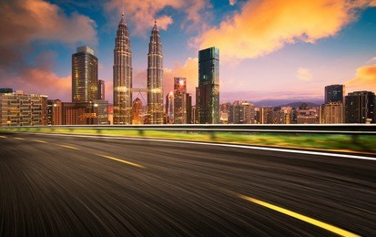 speedy motion forward flyover with beautiful kuala lumpur city skyline , sunset scene .