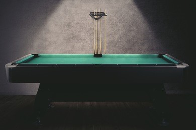 picture of green billiard table with sticks. shot in the billiard room