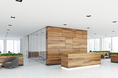 side view of a wooden reception desk standing in an open space office environment with rows of computer tables and loft windows. 3d rendering mock up
