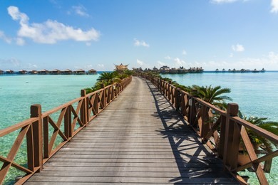 bridge and bungalows with a blue ocean, paradise island, mabul island in borneo