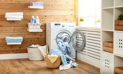interior of a real laundry room with a washing machine at the window at home
