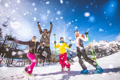 group of friends with ski on winter holidays - skiers having fun on the snow