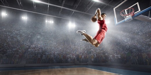 basketball player on big professional arena during the game. he is wearing unbranded clothes.