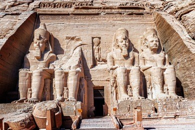 statues at the entrance to the temple of king ramses ii in abu simbel in egypt.