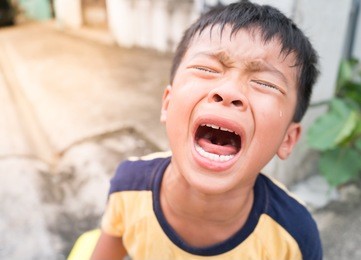 little asian boy crying bitterly