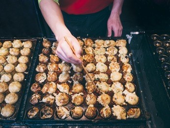 cooking takoyaki on hot pan famous food osaka japan street food