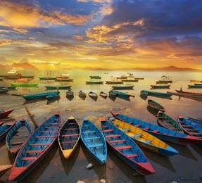 twilight with boats on phewa lake, pokhara, nepal