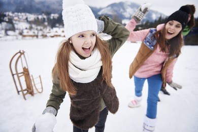 family snowball fight in winter 
