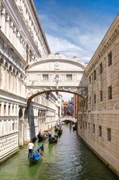 gondolas under the bridge of sighs, a romantic tradition in venice, italy