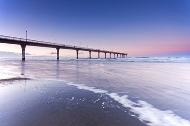 pier at new brighton beach sunset view in christchurch, south island, new zealand.