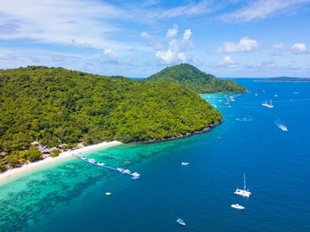 aerial view or top view of tropical island beach with clear water at banana beach, coral island, koh hey, phuket, thailand