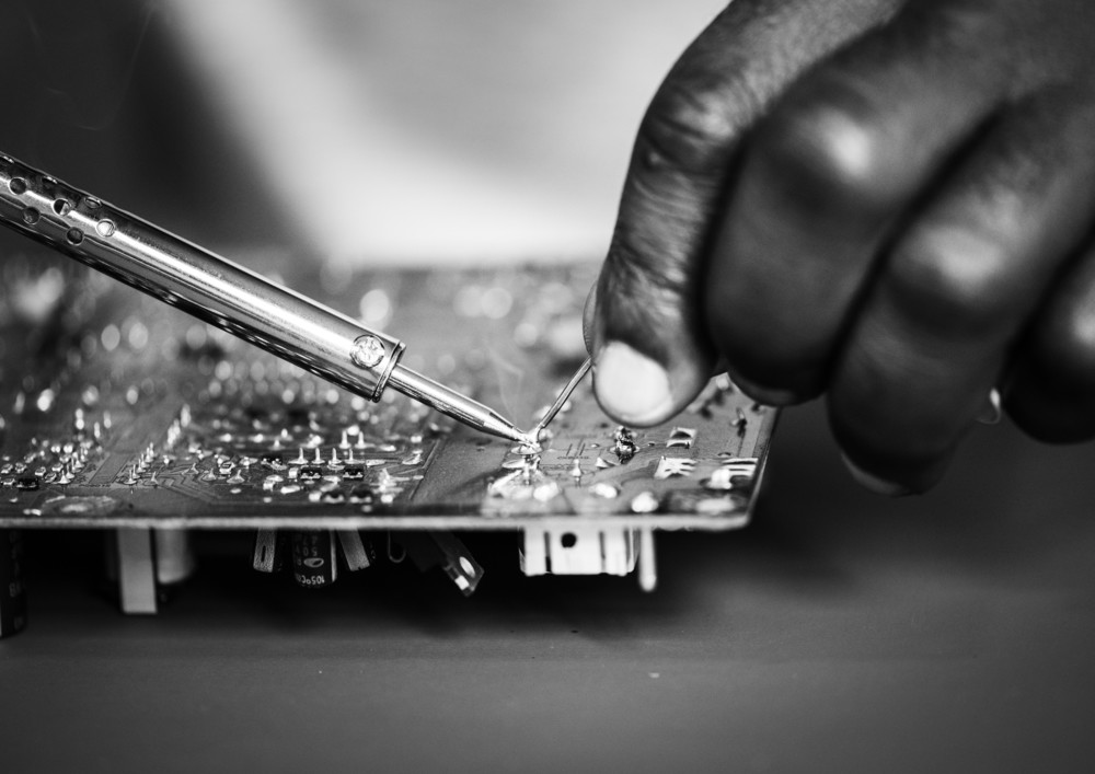 closeup of tin soldering with electronics circuit board