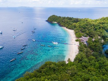 aerial view or top view of tropical island beach with clear water at banana beach, coral island, koh hey, phuket, thailand