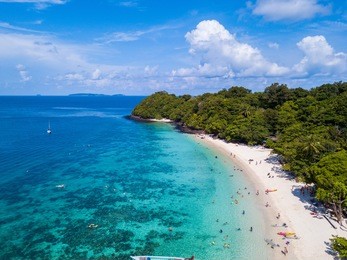 aerial view or top view of tropical island beach with clear water at banana beach, coral island, koh hey, phuket, thailand