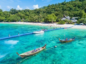 aerial view or top view of tropical island beach with clear water at banana beach, coral island, koh hey, phuket, thailand