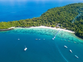 aerial view or top view of tropical island beach with clear water at banana beach, coral island, koh hey, phuket, thailand