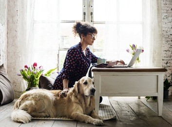 woman petting golden retriever dog