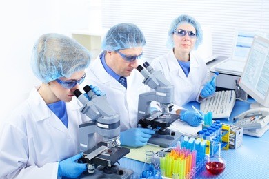 science team working with microscopes at  laboratory