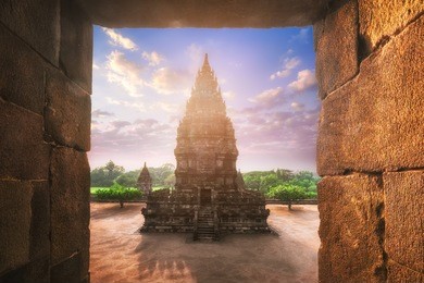beautiful buildings of ancient prambanan or rara jonggrang hindu temple complex against shining morning sun on background. java, indonesia. amazing touristic landmark at sunrise