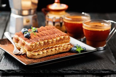 tiramisu cake, homemade tiramisu dessert close-up, traditional italian cuisine.