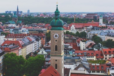 beautiful super wide-angle sunny aerial view of munich, bayern, bavaria, germany with skyline and scenery beyond the city, seen from the observation deck of st. peter church