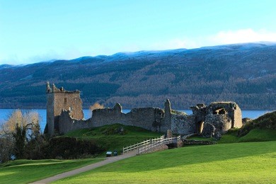 beautiful deserted view of the urquhart castle ruins and loch ness on an early winter's day.