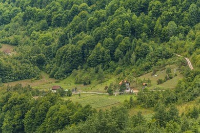 countryside in the mountains with small houses and woods