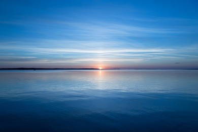 golden blue sunset on water horizon.