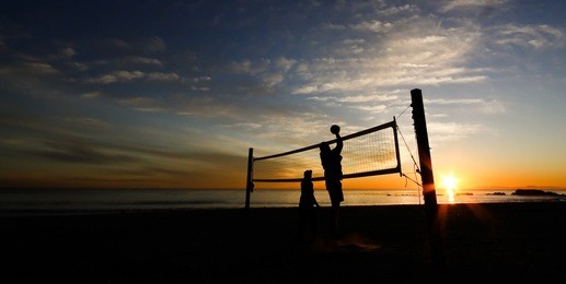 beach volleyball practice at sunset