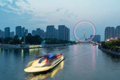 tianjin hai river waterfront downtown skyline with big ferris wheel named "tianjin eye",china.