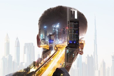 rear view of businessman's head with illuminated highway at night