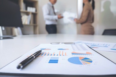 business people conference, two confident executive colleagues meeting and discussing, working in business strategy and financial plan to investment profit on graph and chart.