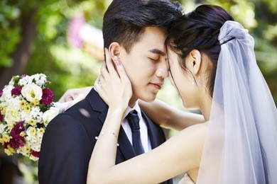 young asian bride and groom kissing at wedding ceremony
