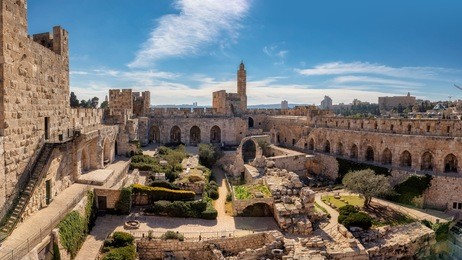 panorama of david's tower in old city of jerusalem with view of the new jerusalem in the distance. israel.