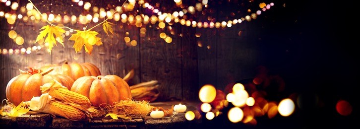 happy thanksgiving day background, wooden table decorated with pumpkins, corncob, candles and garland. halloween. beautiful holiday autumn festival concept scene fall, harvest