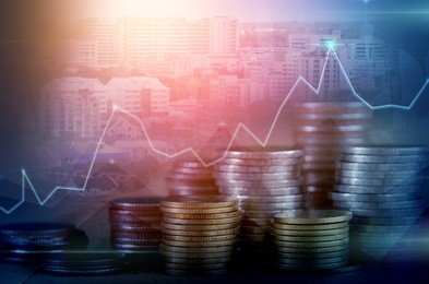 double exposure of city and rows of coins for finance and banking concept