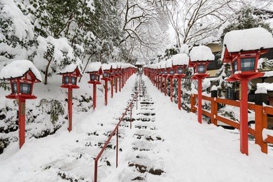 stone stair and traditional light pole with snow fall in winter at kifune shrine , kyoto prefecture , japan