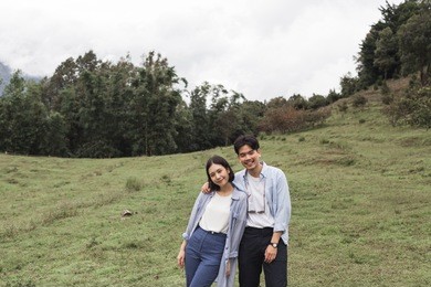a portrait of a young man and woman couple have fun, enjoy holiday, happy life, love at mountain. pre-wedding concept.